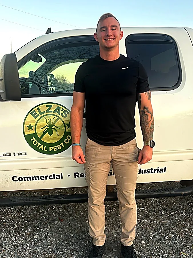 Bret Elza, owner of Elza’s Total Pest Control, standing by his service truck in Oklahoma